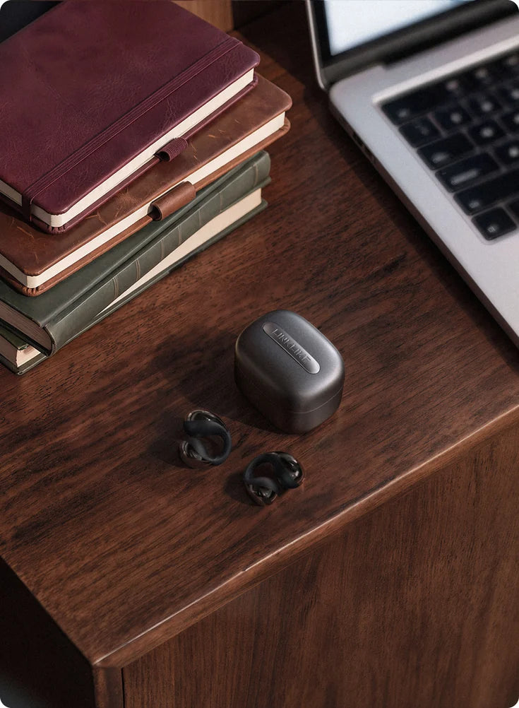 C-Flow earbuds on a desk
